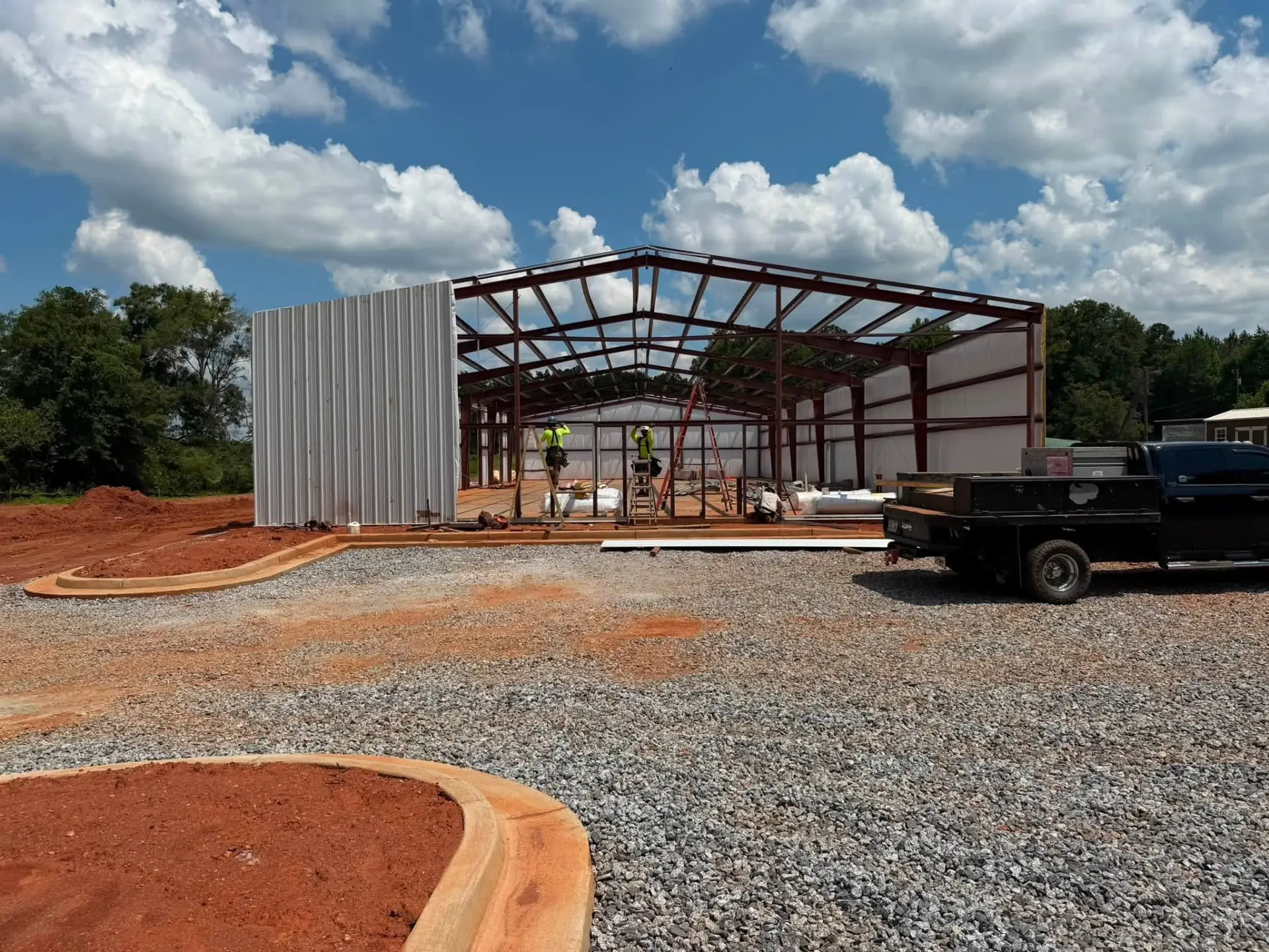 Steel frame with partial wall sheeting on a commercial PEMB